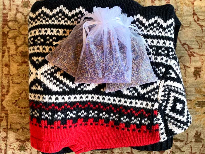 Sweater on carpet with lavender buds pouch of aromatic dried lavender