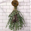 Eucalyptus hanging from shower head with fresh lavender and twine