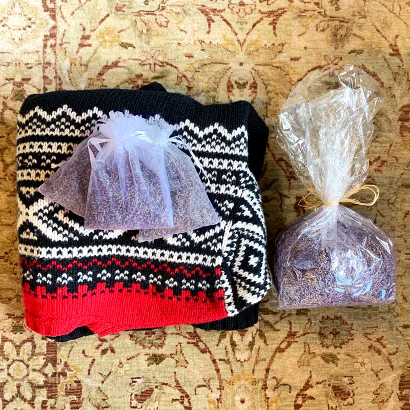 Sweater on carpet with lavender buds pouch of aromatic dried lavender bag of lavender on ground