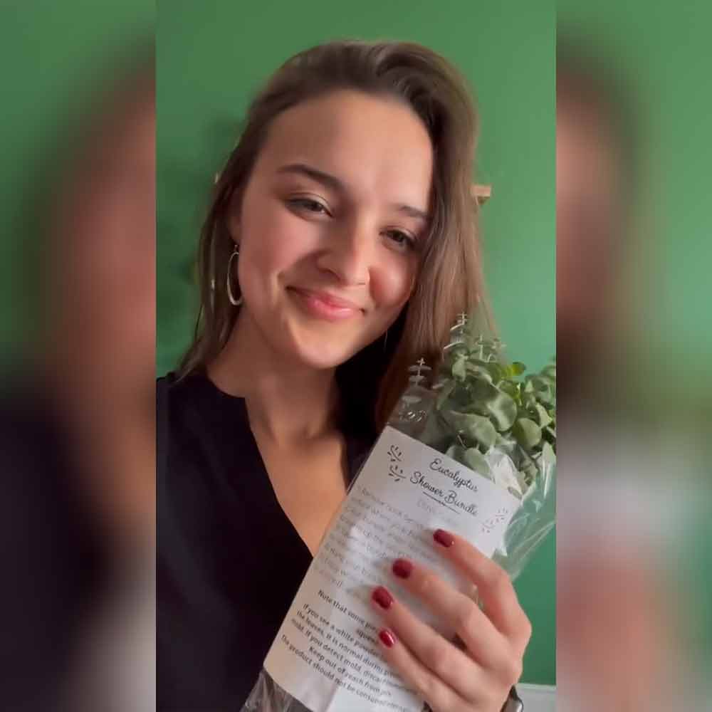 Customer holding a Self-Care Shower fresh eucalyptus bundle package